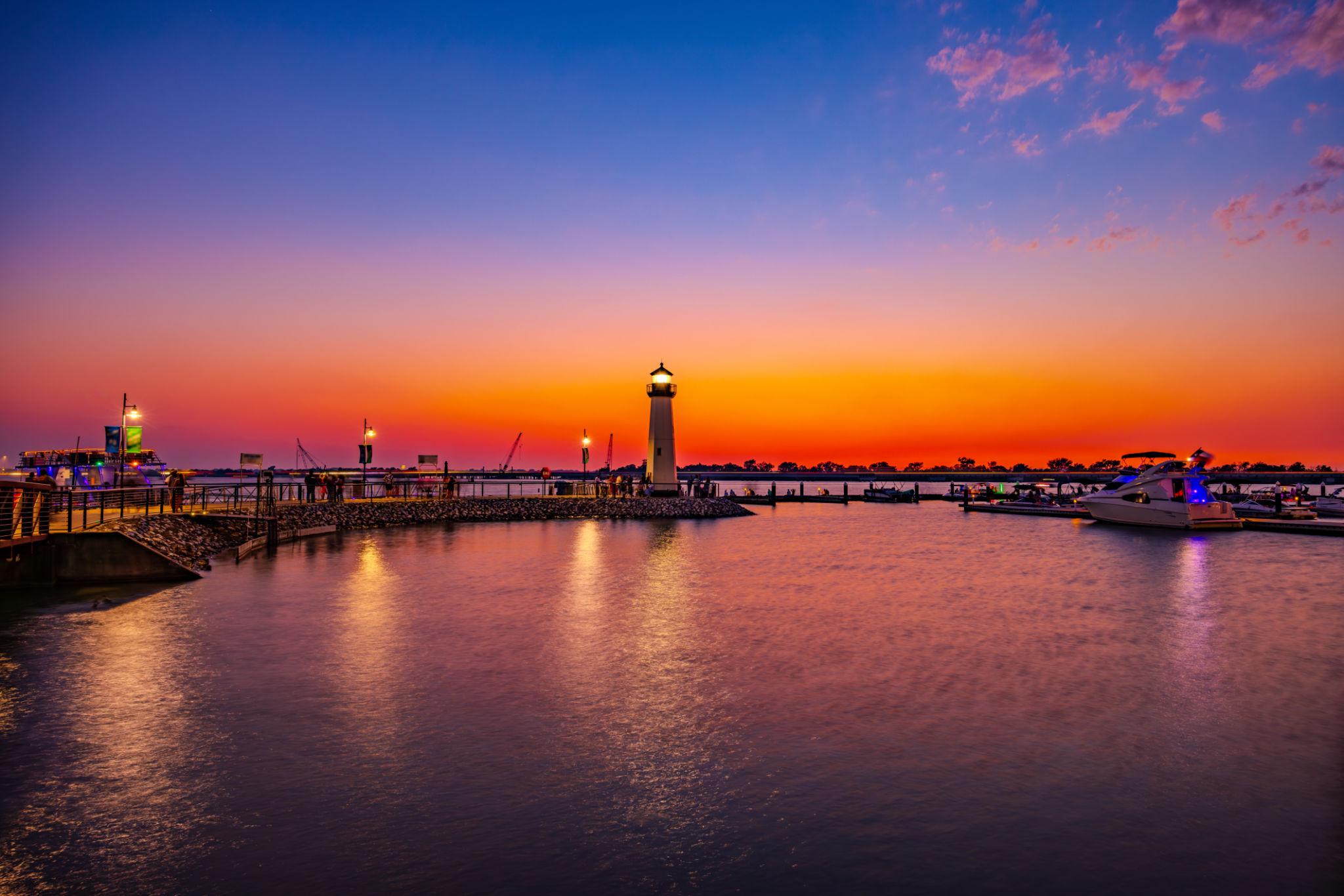 the rockwall harbor with a sunset in the back